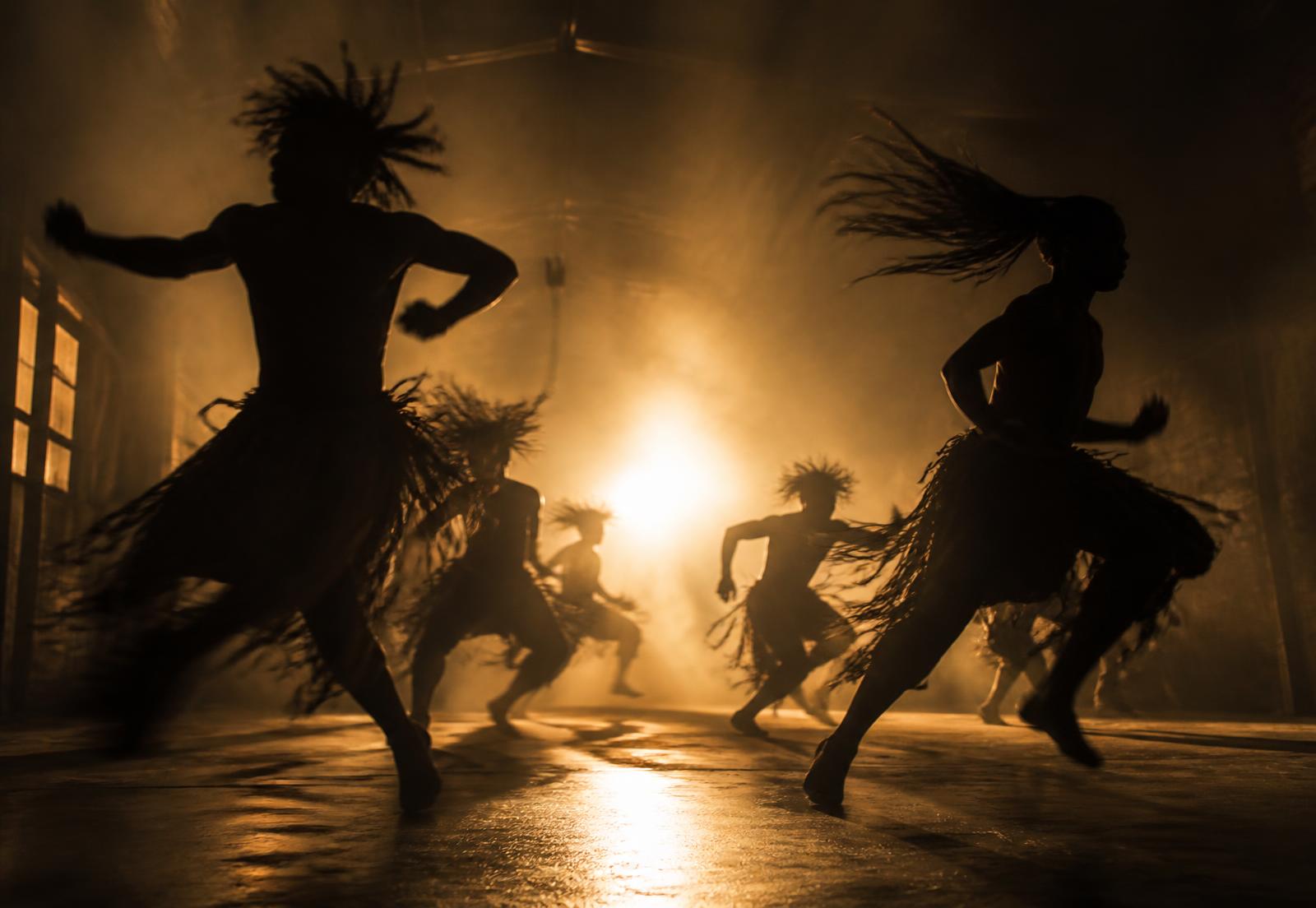 Dancers performing under stage light